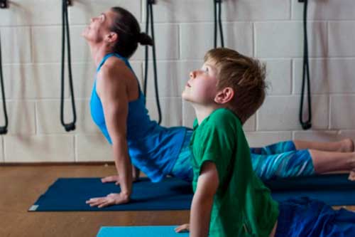 yoga for children Perth child and teacher in upward facing dog pose